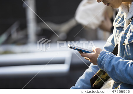 Hand of young men who operate smartphone Hand of young men who operate smartphone 47566966
