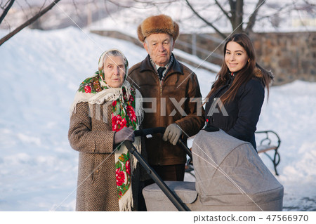 Great Grandparents walking with their granddaughter and great granddaughter Great Grandparents walking with their granddaughter and great granddaughter 47566970