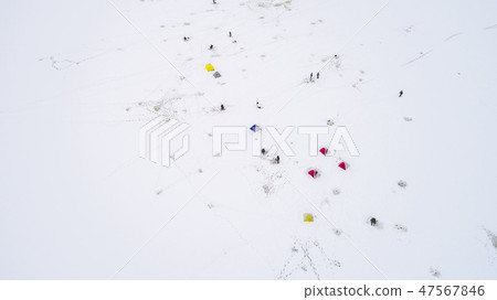 Aerial view of winter fishing. Fishermen set up tents for fishing at night. Aerial view of winter fishing. Fishermen set up tents for fishing at night. 47567846