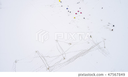 Aerial view of winter fishing. Fishermen set up tents for fishing at night. 47567849
