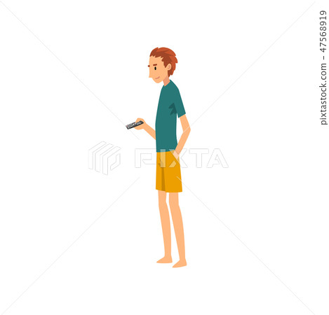 Young Man Standing and Holding Remote Control, Guy Spending Weekend at Home and Relaxing, Rest at 47568919