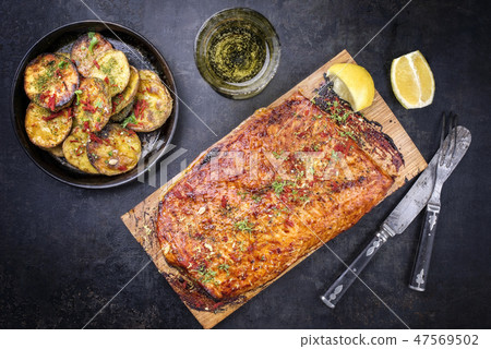 Barbecue salmon fillet marinated on cedar plank Barbecue salmon fillet marinated on cedar plank 47569502