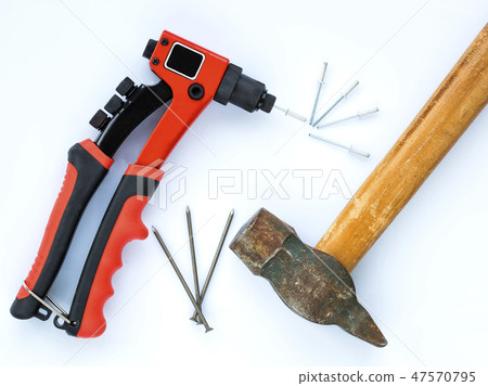 Old hammer nails against new Rivet Gun and Rivets 47570795