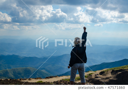 Woman on mountain top 47571860