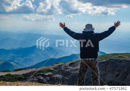 Hiker watching a landscape Hiker watching a landscape 47571862
