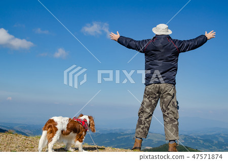 Man and his dog in a landscape 47571874