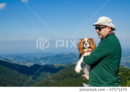 Man and dog in a landscape 47571879