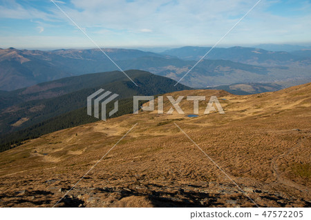 Panoramic view of idyllic mountain scenery in sunny day Panoramic view of idyllic mountain scenery in sunny day 47572205