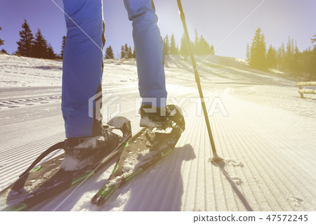 wallking in snow with snowshoe 47572245