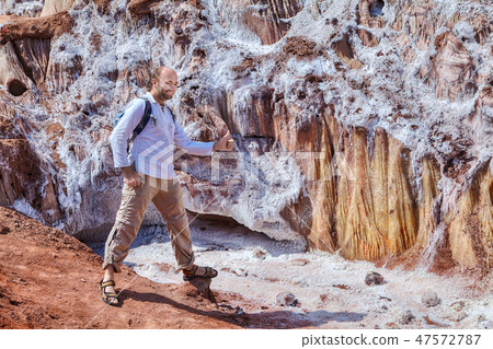 Traveler posing for photograph near salty glacier 47572787