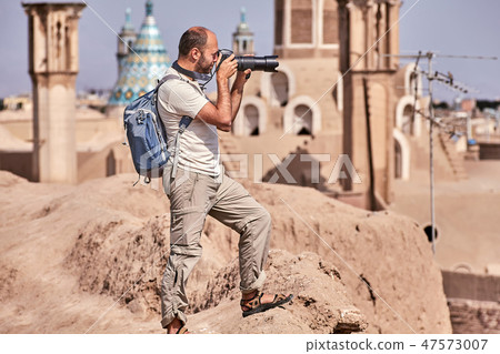 Solo tourist photographs an ancient city  47573007