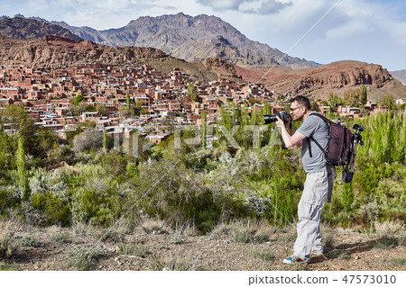 One caucasian man photographing village of Abyaneh 47573010