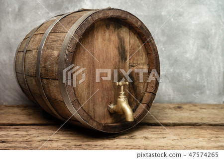 Wooden barrel with tap and worn old table of wood. 47574265