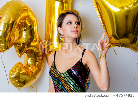 woman with golden balloons on her thirty years birthday 47574925