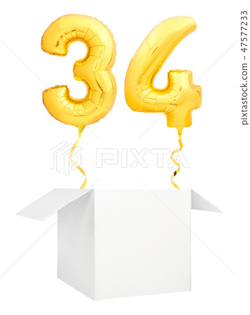 Golden number thirty four inflatable balloon with golden ribbon flying out of blank white box 47577233