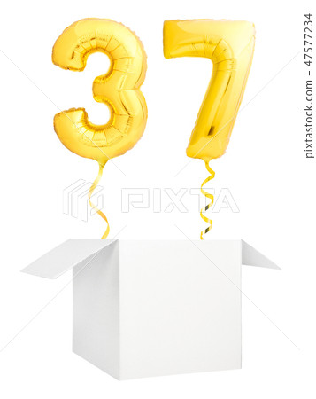Golden number thirty seven inflatable balloon with golden ribbon flying out of blank white box 47577234