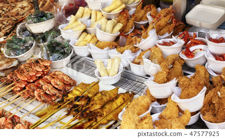 Street food stall with assortment of snacks. 47577925