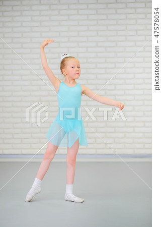 Cute little ballerina in blue dress dancing at ballet class. 47578054