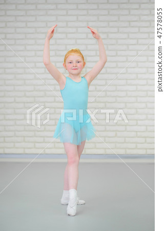 Cute little ballerina in blue dress dancing at ballet class. 47578055
