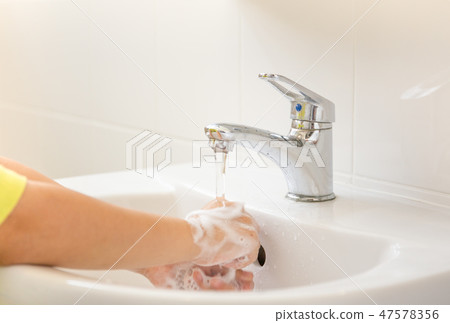Children with soapy hands washed in bathroom sink. 47578356