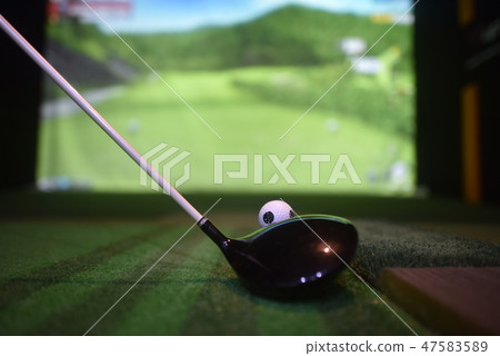 Drivers and golf balls on a screen golf course 47583589