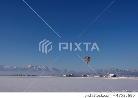 Winter landscape of Furano where hot air balloon floats 47585690