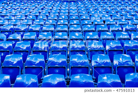 Many bright blue stadium seats perspective shot 47591013