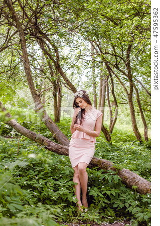 Perfect young woman in flowers garden outdoors 47595362