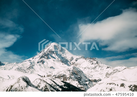 Georgia. Peak Of Mount Kazbek Covered With Snow. Kazbek Is A Stratovolcano And One Of Major 47595410