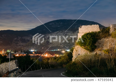 Terracina, Italy. Night View Of Road Near Remains Old Roman Fortress Wall With Towers Terracina, Italy. Night View Of Road Near Remains Old Roman Fortress Wall With Towers 47595641