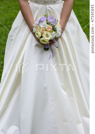 Beautiful wedding a bouquet in hands of the bride 47595845