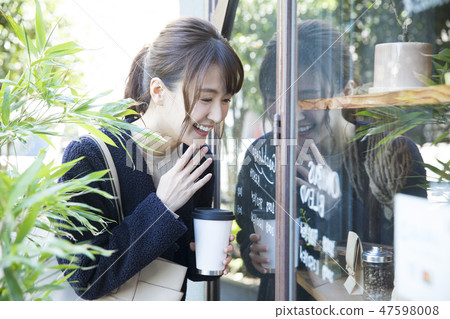 A woman watching a show window 47598008