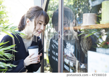 A woman watching a show window 47598010