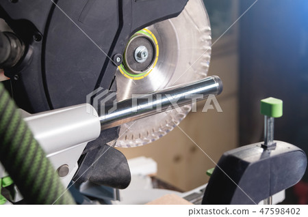 Close-up manual saw blade circular saw with plastic protection on the slides for cutting wood in the Close-up manual saw blade circular saw with plastic protection on the slides for cutting wood in the 47598402