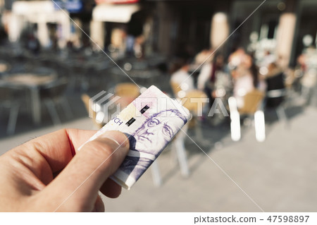 man paying the bill with czech korunas 47598897
