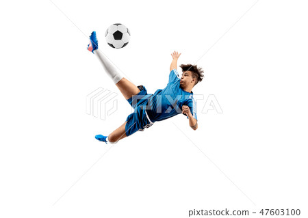 Young Boy With Soccer Ball Doing Flying Kick Stock Photo