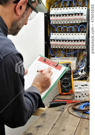 Electrician at work on an electrical panel Electrician at work on an electrical panel 47603688