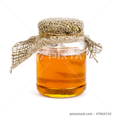 Glass jar with delicious fresh honey isolated Glass jar with delicious fresh honey isolated 47604150