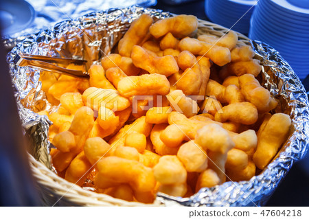 Youtiao (Chinese churros, deep fried dough strips) 47604218