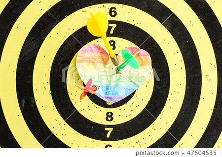 A target with darts in the center of which the crumpled heart of LGBT, same-sex marriages 47604535