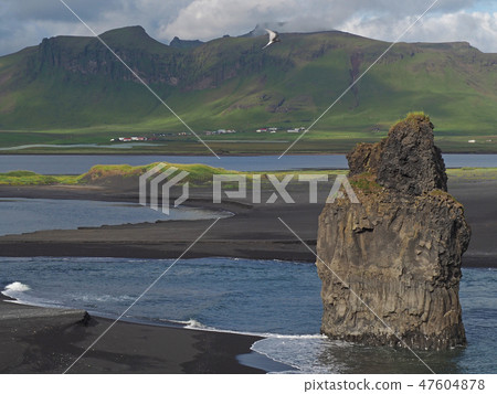 magic iceland landscape with black lava sand and green eroded hills 47604878