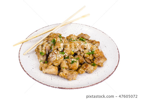 Plate with slices of chicken in batter with sesame 47605072