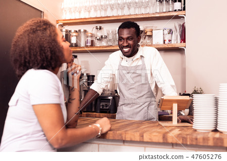 Joyful pleasant man working in the cafeteria 47605276
