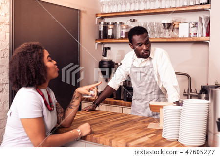 Nice joyful woman pointing with her finger Nice joyful woman pointing with her finger 47605277