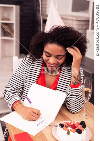 Joyful positive woman thinking what to do 47605683