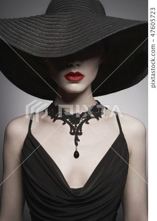 portrait of young lady with black hat and evening dress 47605723