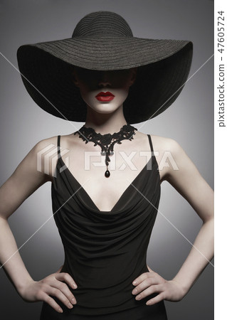 portrait of young lady with black hat and evening dress 47605724