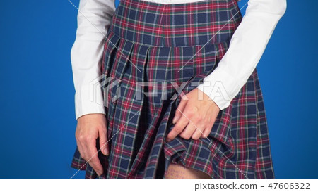 Midsection of teenage girl, cheat sheet written on hips hidden under a skirt. close-up, blue Midsection of teenage girl, cheat sheet written on hips hidden under a skirt. close-up, blue 47606322