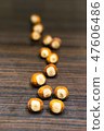 Whole hazelnuts on a wooden table.  47606486