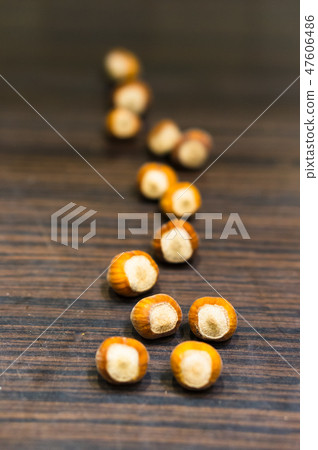 Whole hazelnuts on a wooden table. Whole hazelnuts on a wooden table. 47606486